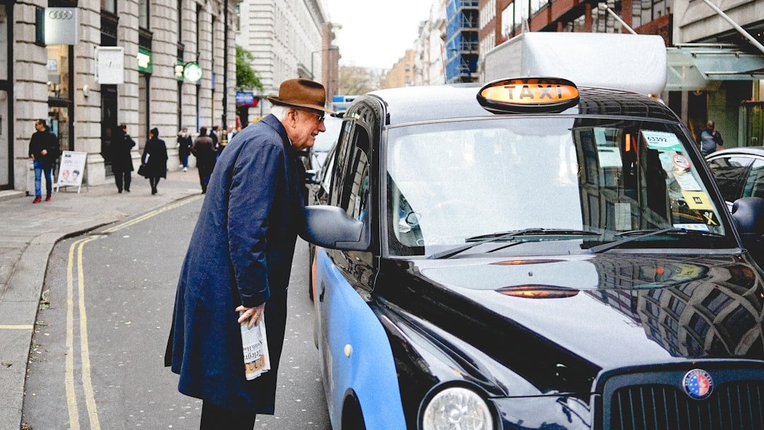 man-talking-through-taxi-car-mirror-during-daytime-dbcatwbagtm